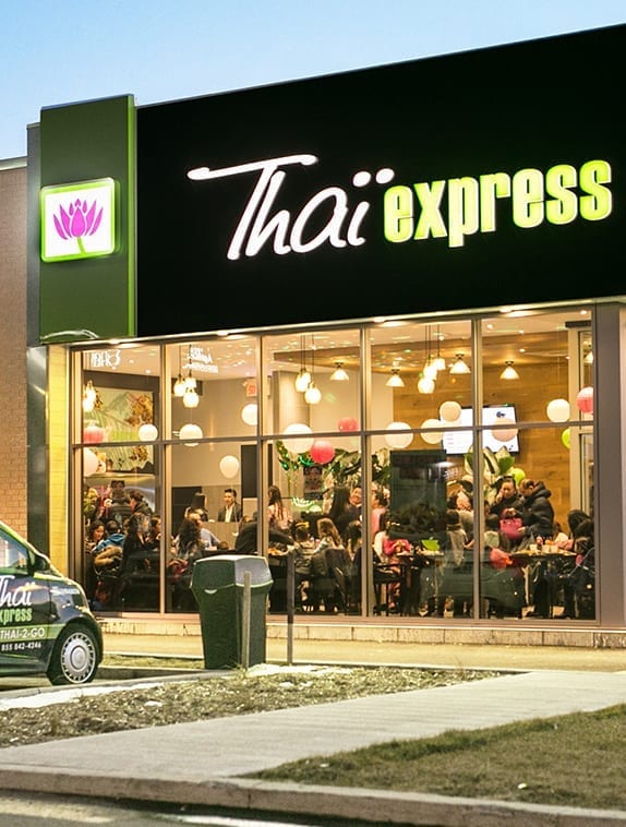 Thai Express front of restaurant with people having dinner inside cozy atmosphere Thai express delivery car parked in front